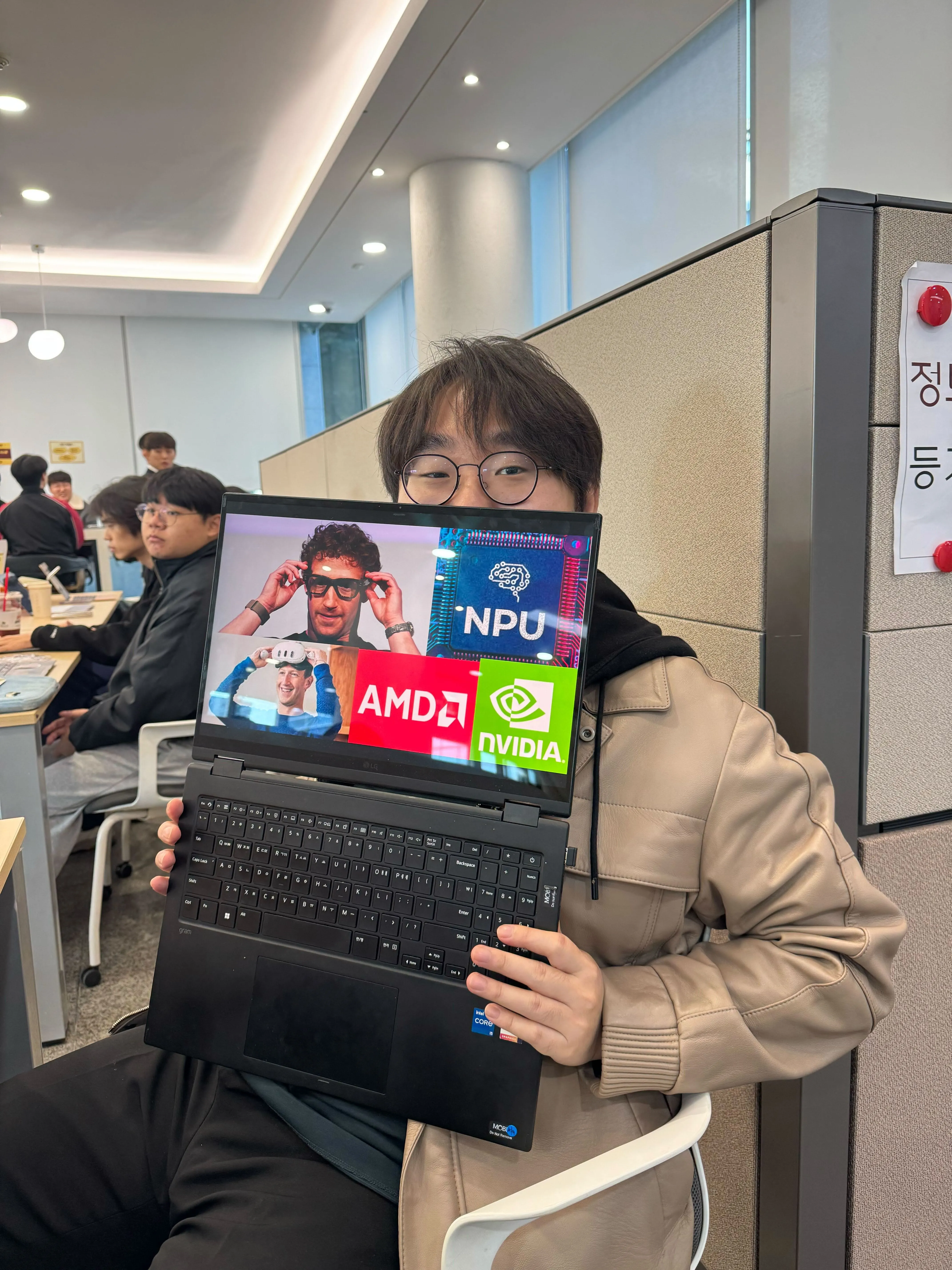A SERA Lab member holding a laptop during a gathering in the lab